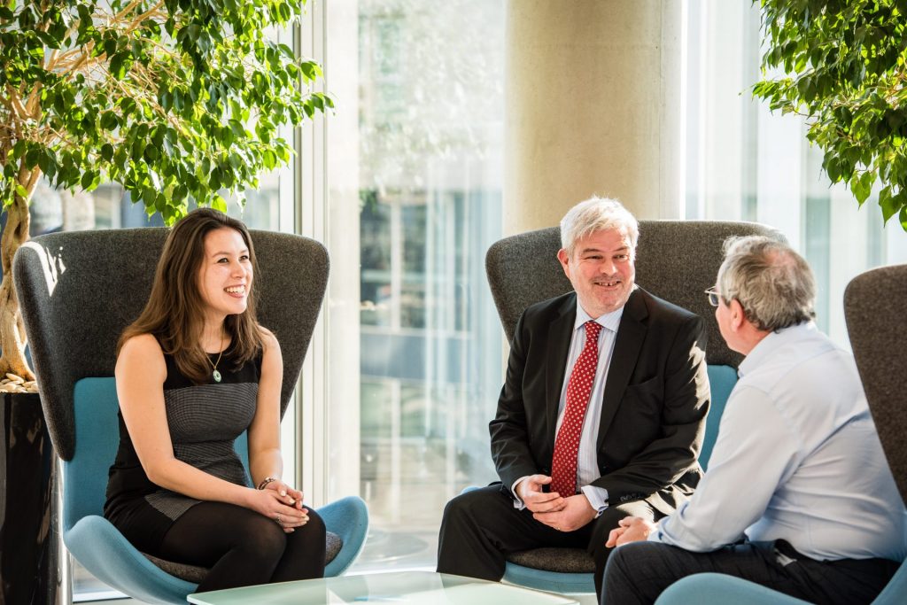 Male and female employees chatting