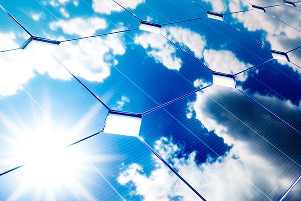 Solar energy concept. Blue sky reflection on photovoltaic panel.